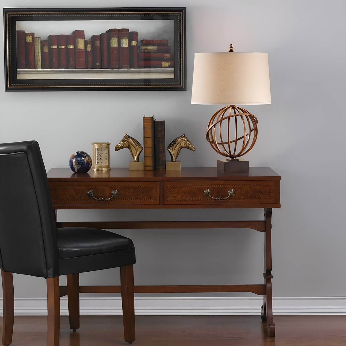 Classic home office with globe-style table lamps, horse bookends, and wall art of books above a wooden desk.