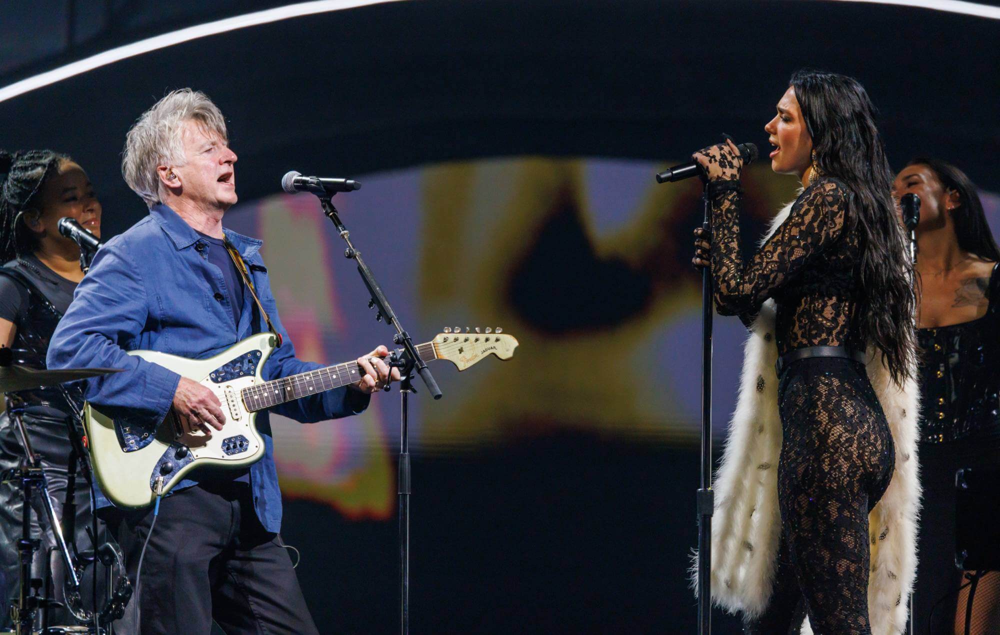 Dua Lipa and Neil Finn on stage