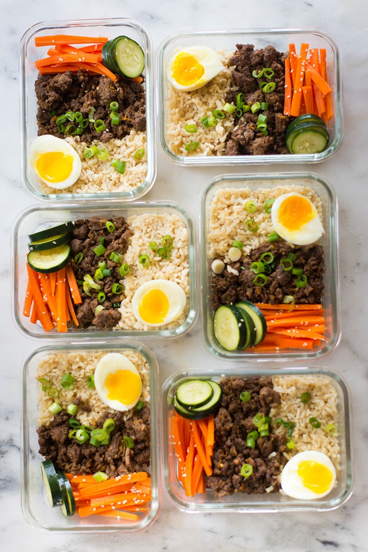 A photo of six meal prep containers full of korean beef bowl.