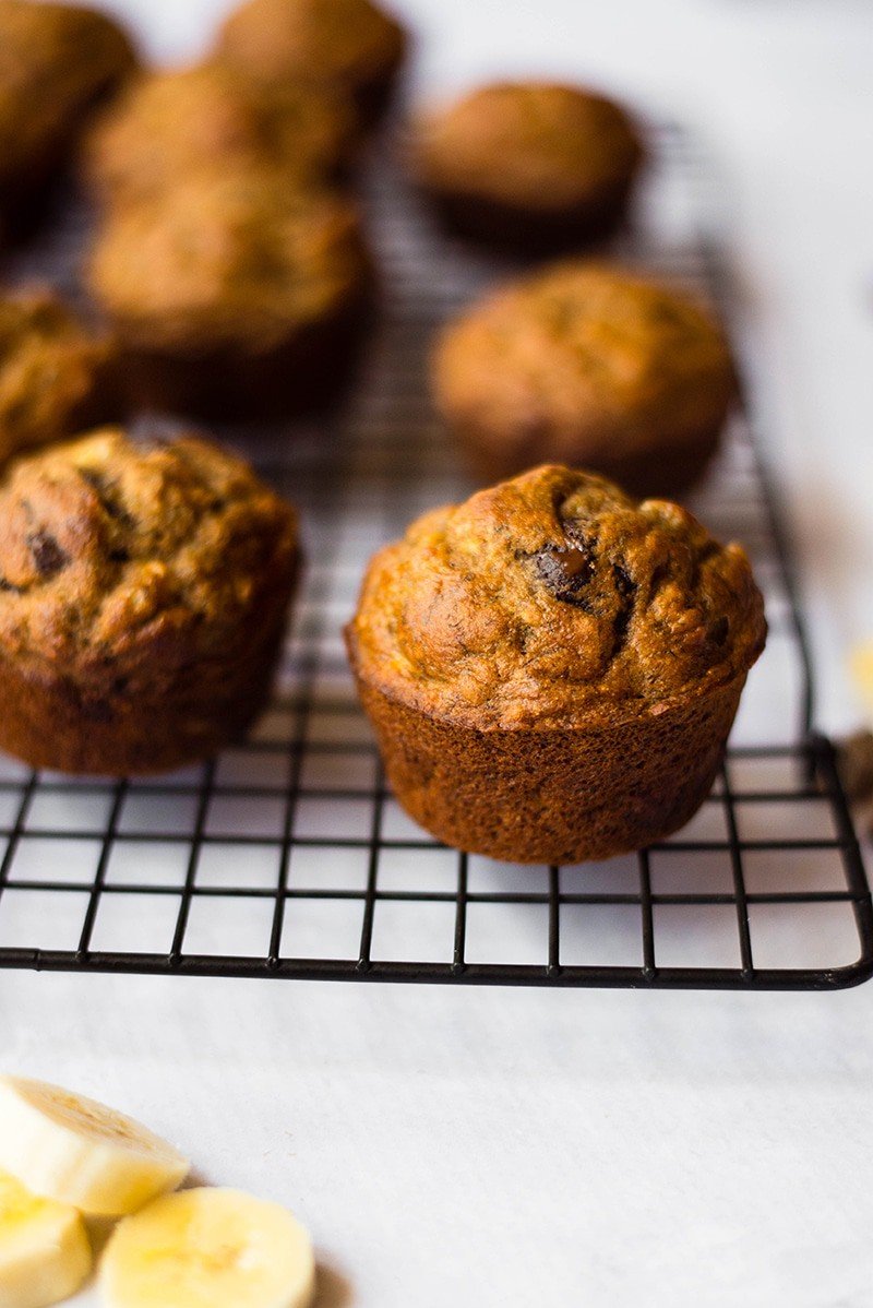 A photo of a muffin rack with healthy banana chocolate chip muffins.