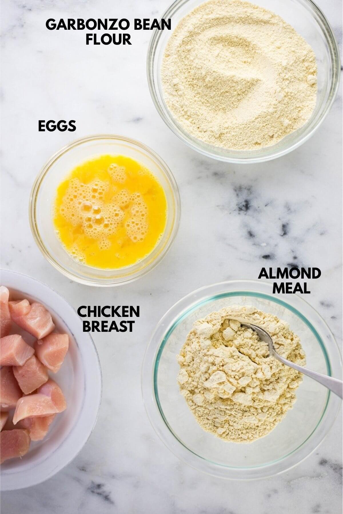 Ingredients for healthy general tso chicken laid out against a white marble surface.