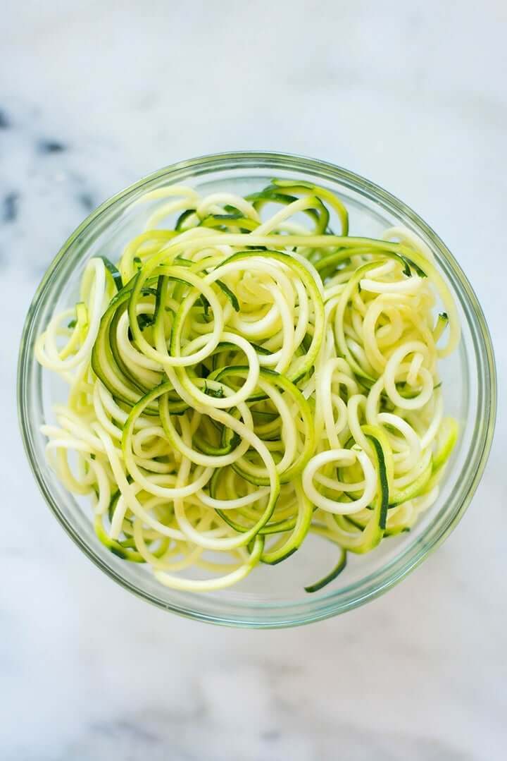 Top view of a bowl filled with freshly spiralized zucchini noodles.