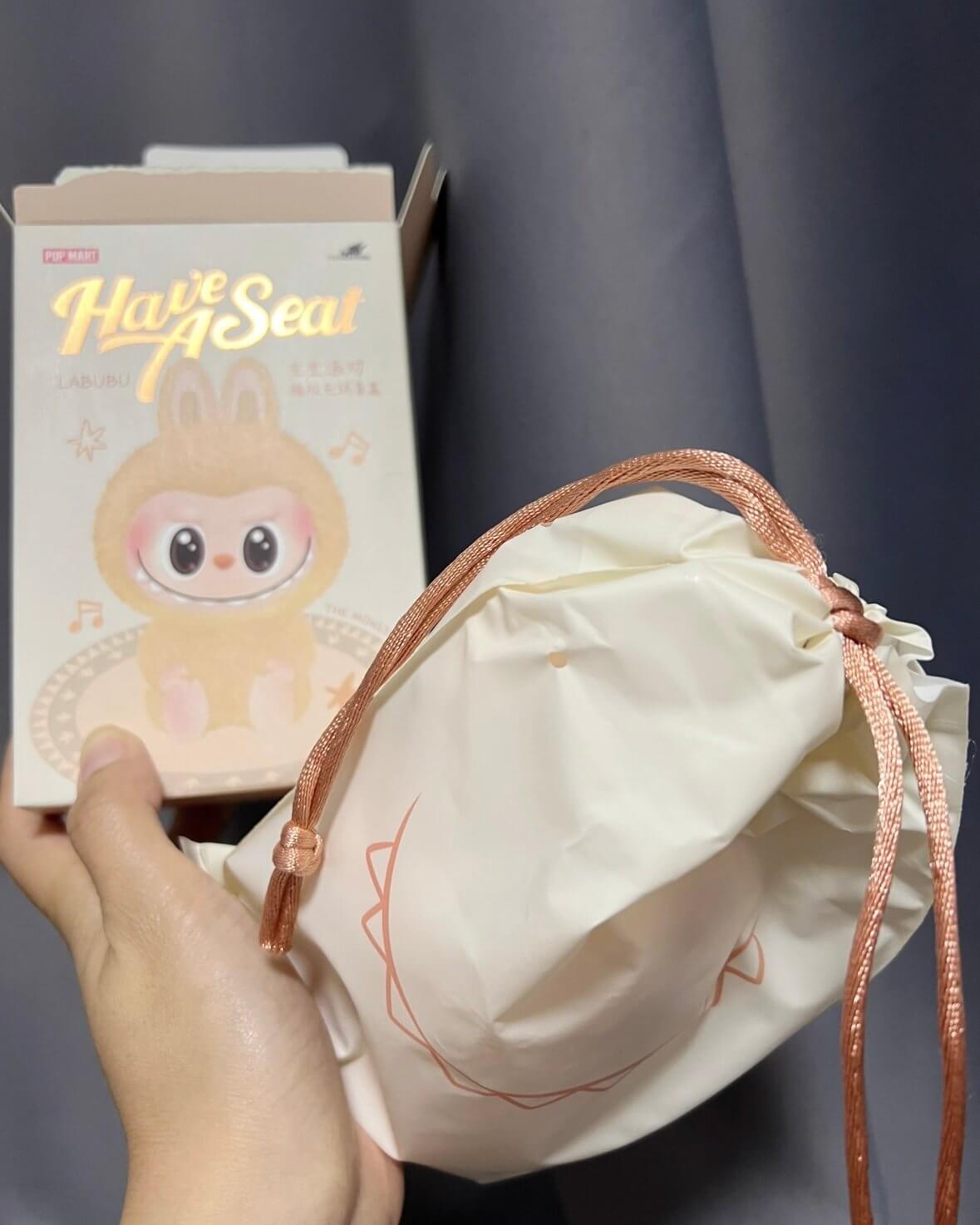 Comparison of old sealed Labubu bag and new reusable drawstring pouch