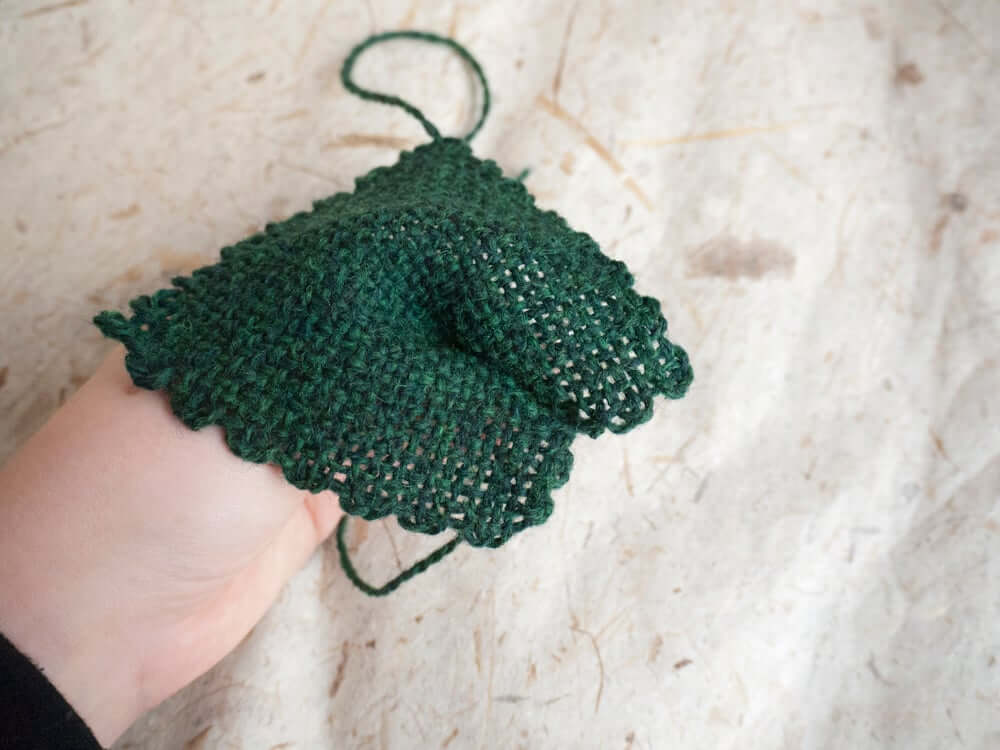 Pinch your green square and make a stitch