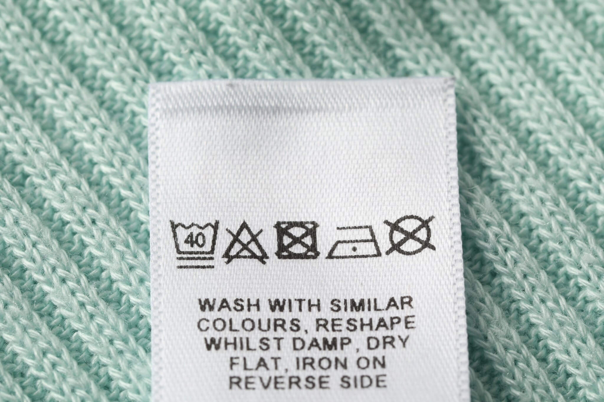 Clothing care essentials including fabric shaver, lint brush, and gentle detergent to extend garment life.