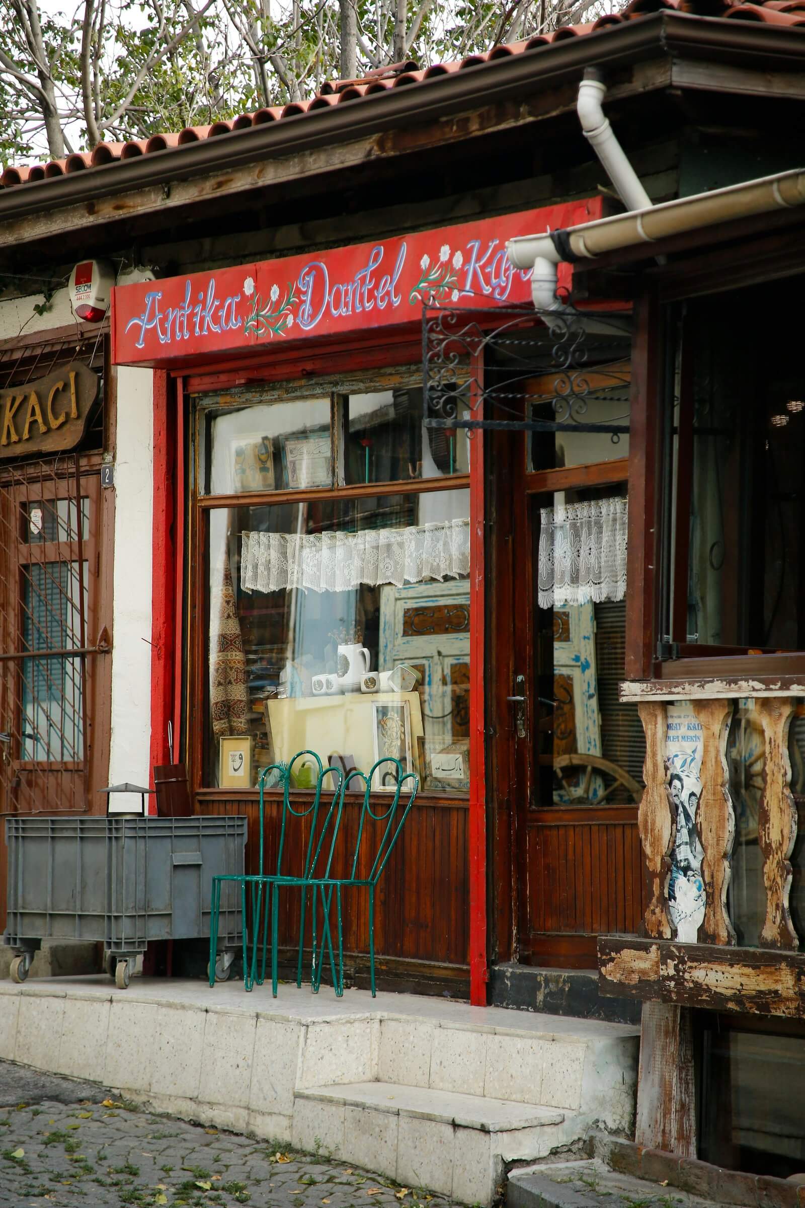 Rustic antique store entrance with vintage decor and wooden detail in a historic neighborhood.
