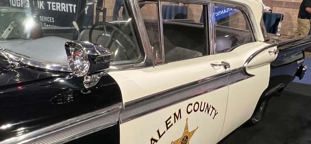 The Police Security Expo showcases classic police cars from various precincts.