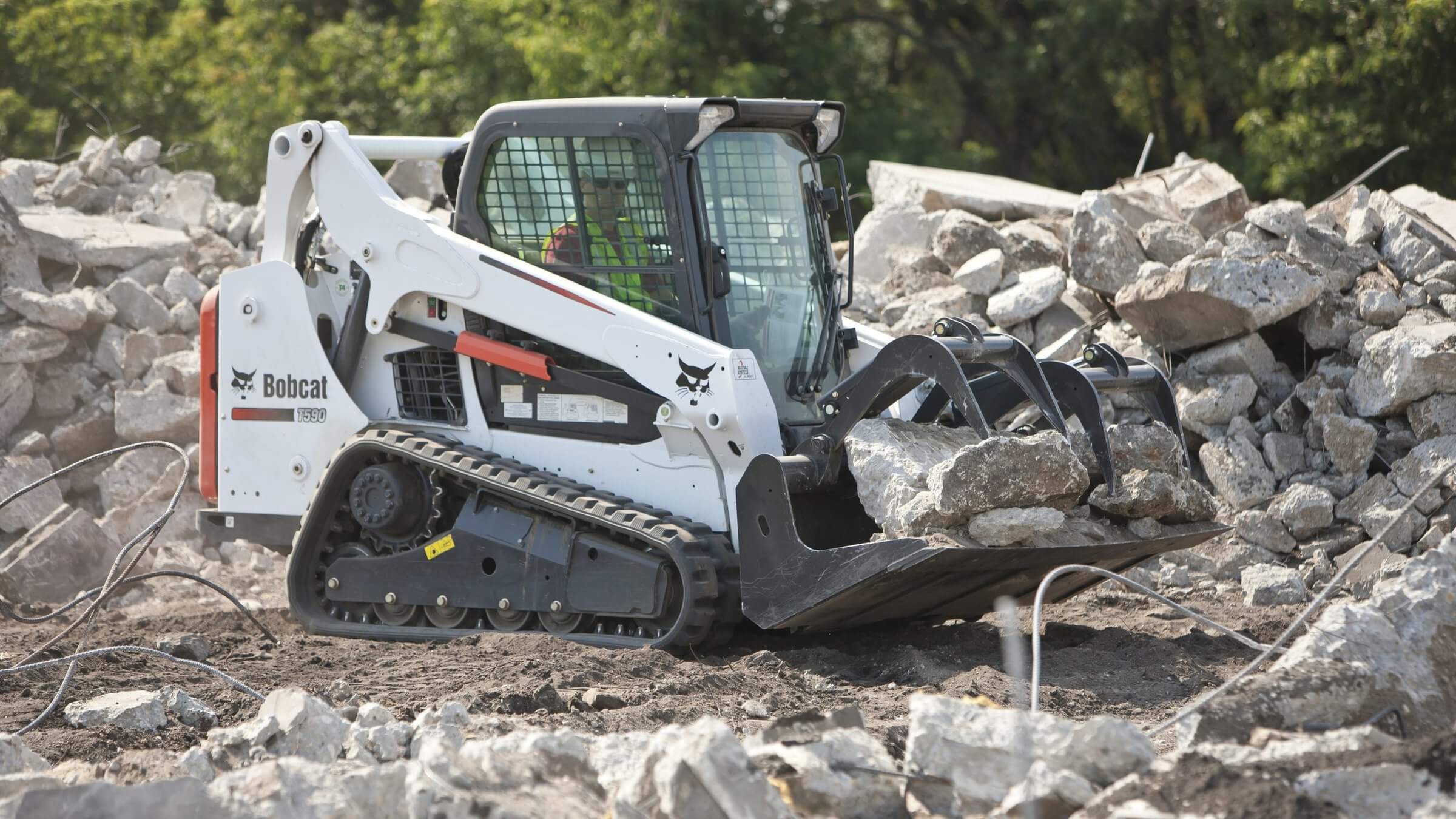 White skid steer loader with modfied wheels which are good for landscaping.