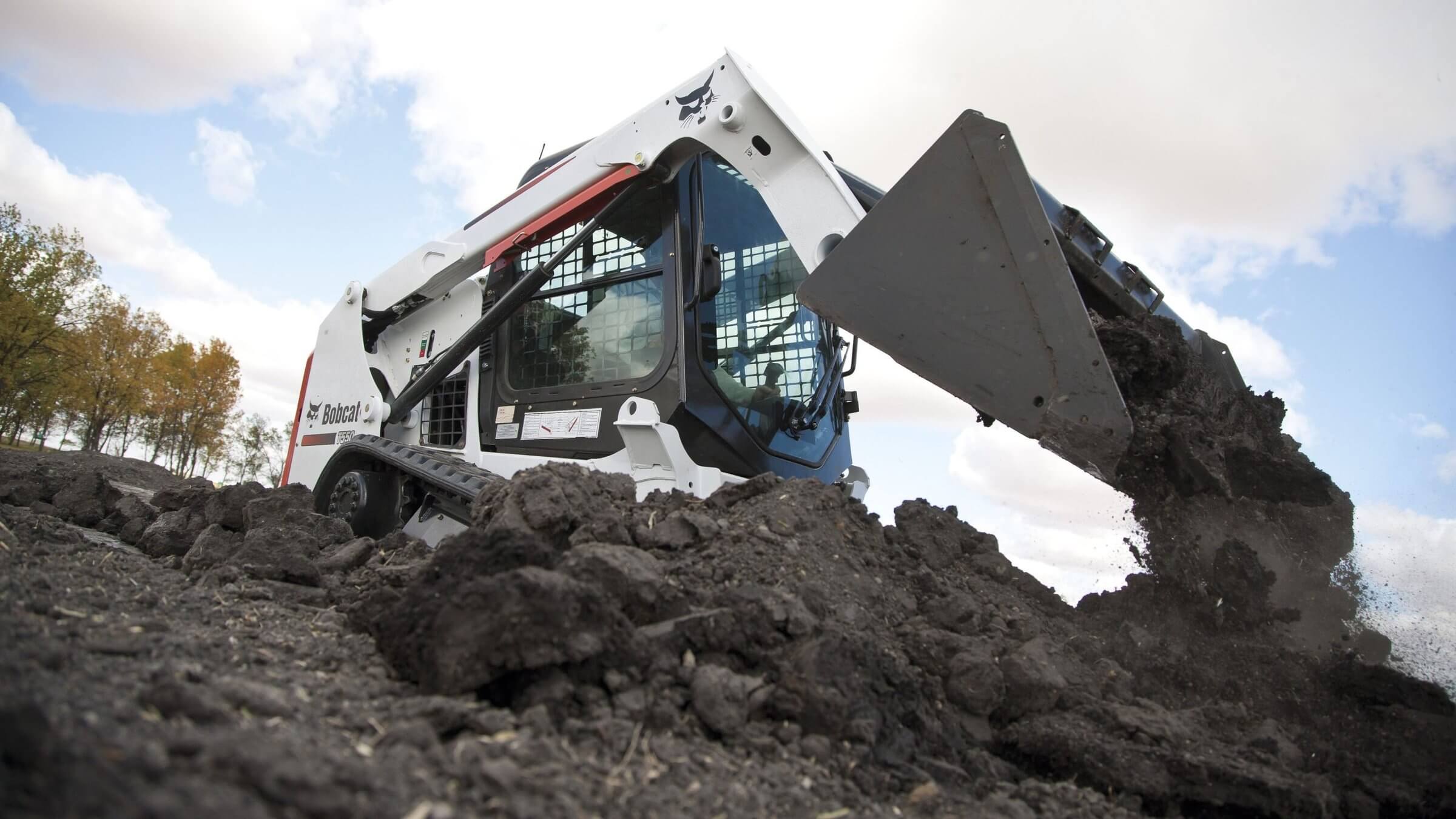 White skid steer loader, good for landscaping and other construction tasks.
