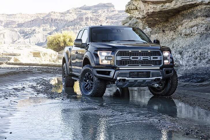 Black Ford F 150, demonstrating the difference between it and the competitors, with regular cab truck bed measuring 96 inches long.