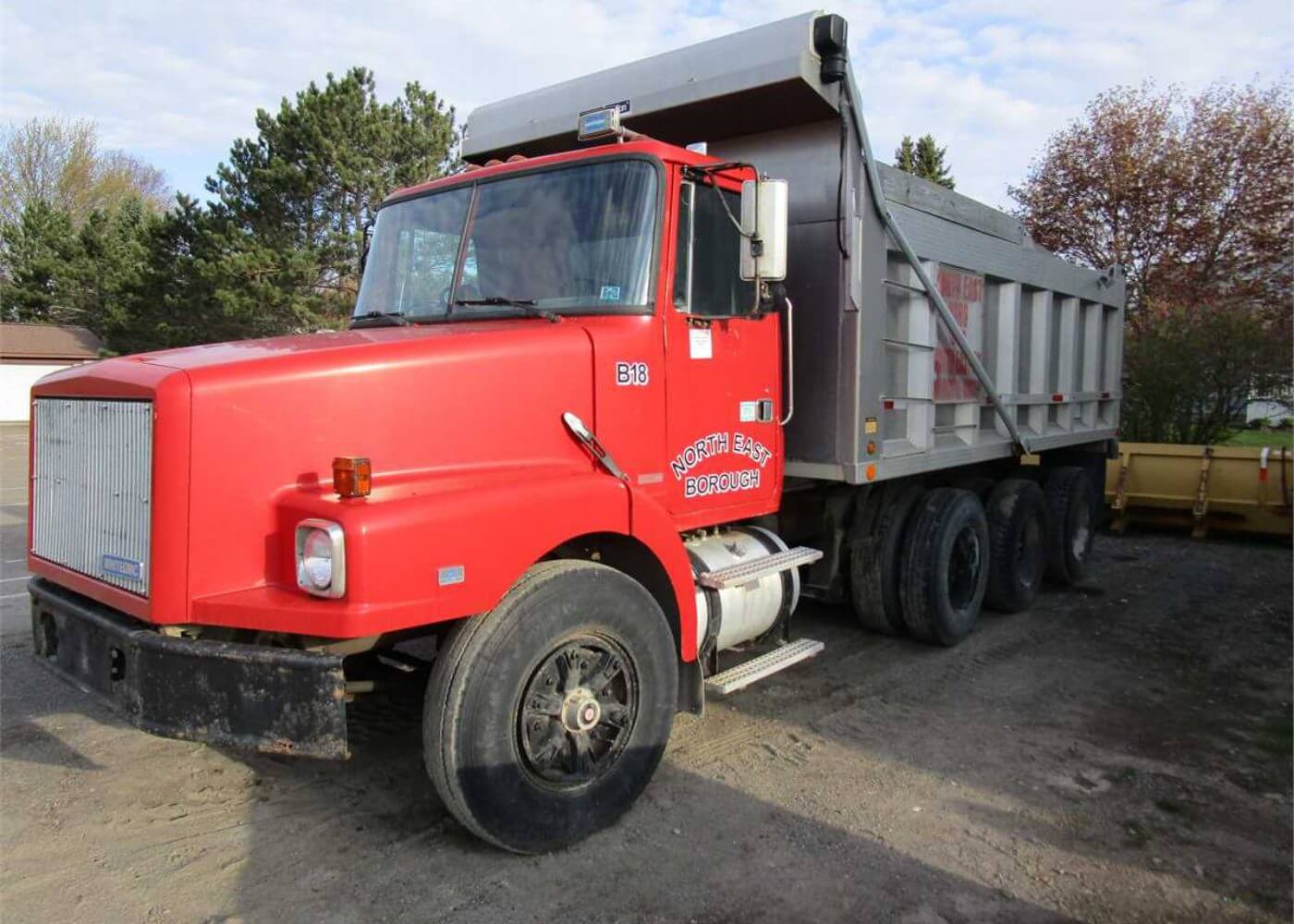 Red and gray standard dump truck