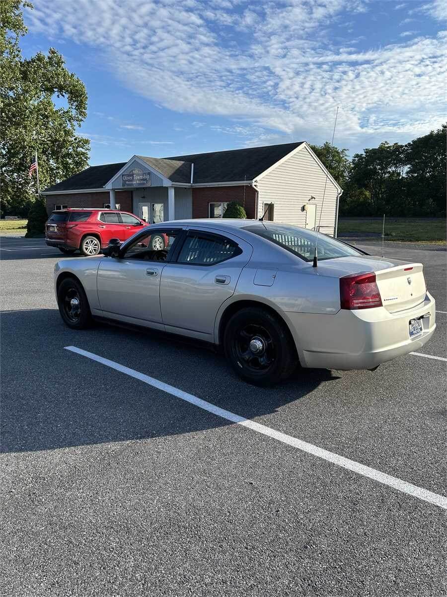 Silver Dodge Charger parked in a parking lot.