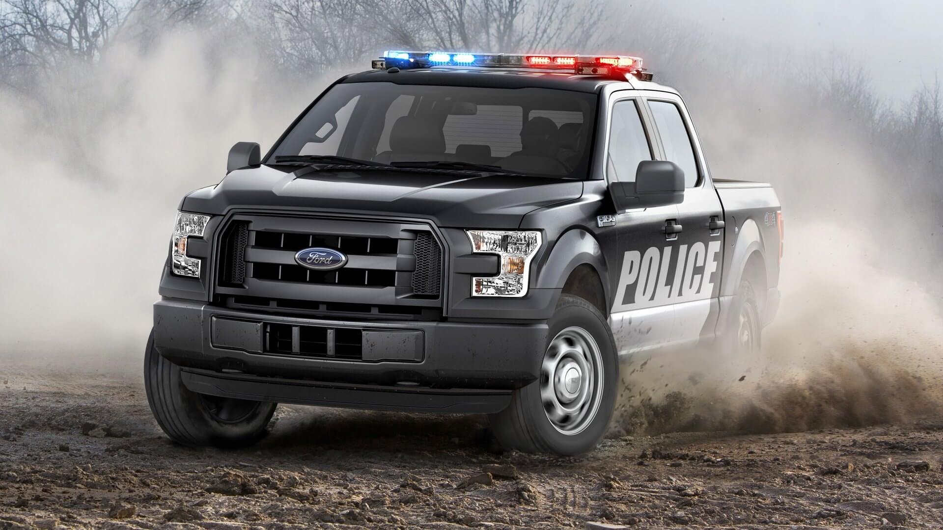 Ford truck used by police forces, drifting in dirt.