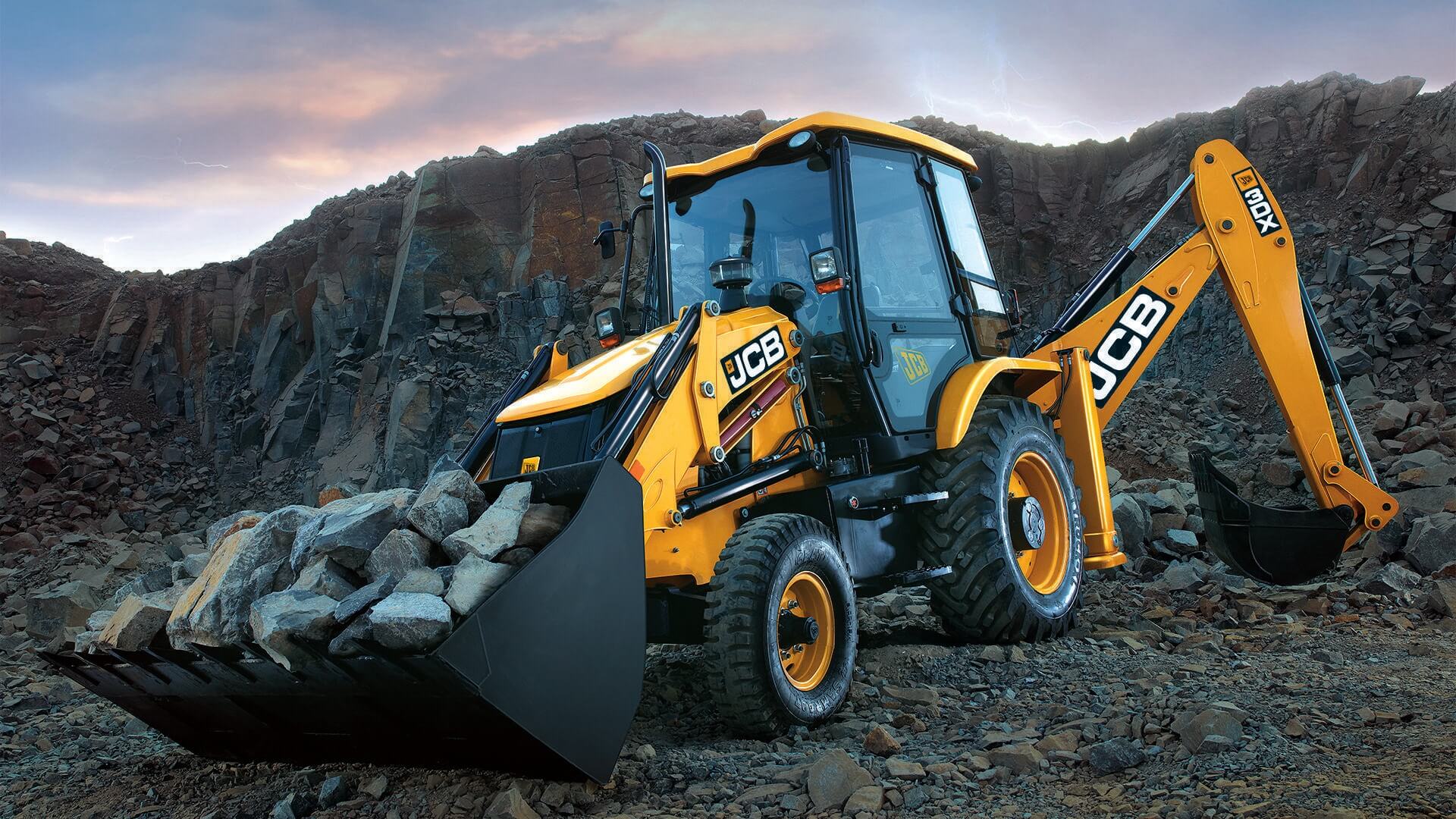 Backhoe loader (backhoes are heavy duty construction equipment) digging rocks.
