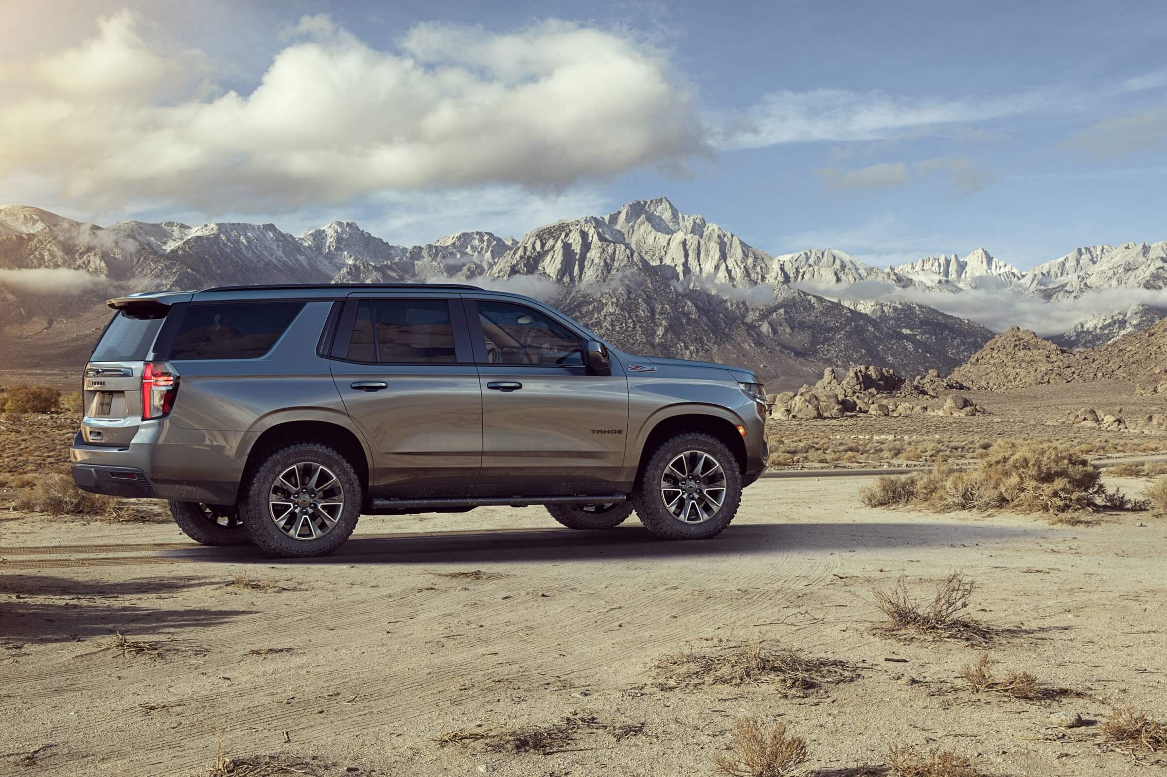 Dark Silver Chevy Tahoe providing a comfortable ride, heated steering wheel and front row bench seat.