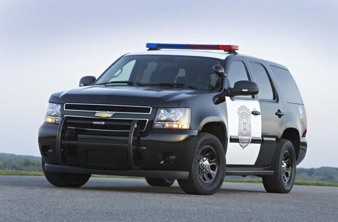 2013 Chevrolet Tahoe Police Pursuit Vehicle parked on a road during traffic enforcement.