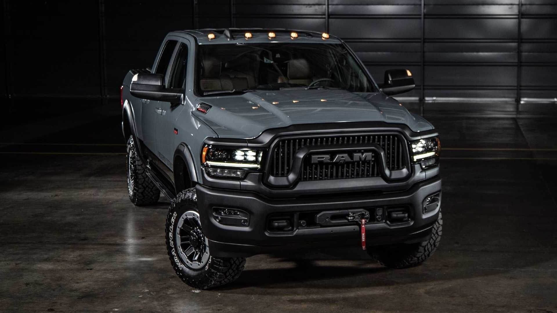 Grey Ram truck with different engine options, impressive off road power, max payload capacity of 4000 pounds, and ability to tow large cargo weight and a flatbed trailer.