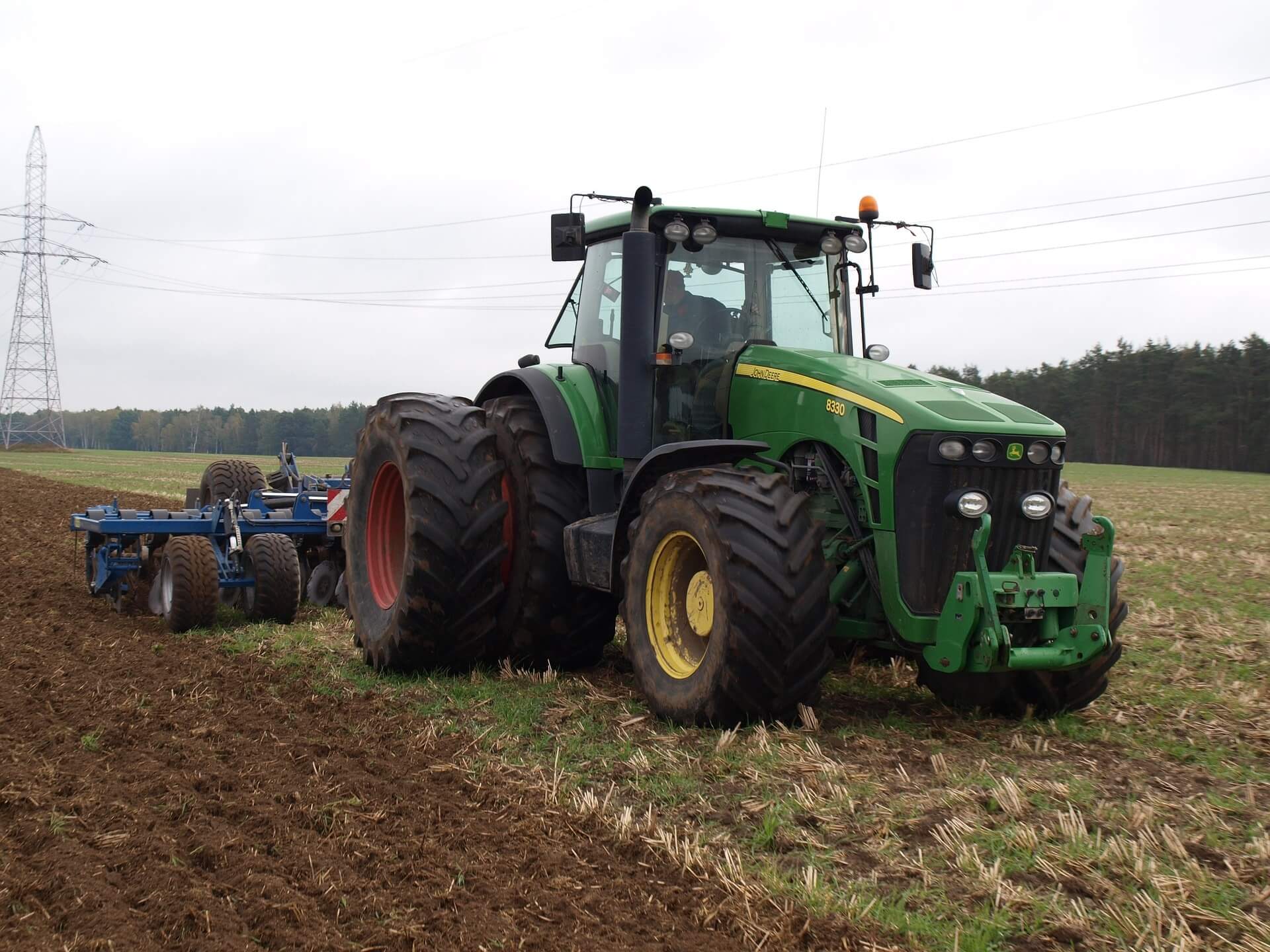 John Deere 8330 row-crop tractor, performing agricultural tasks.