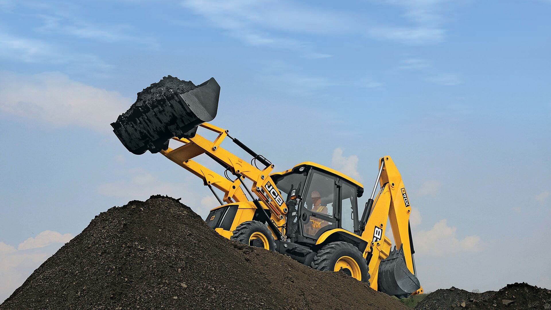 Backhoe loader (excavation machines and crucial construction equipment) moving dirt.