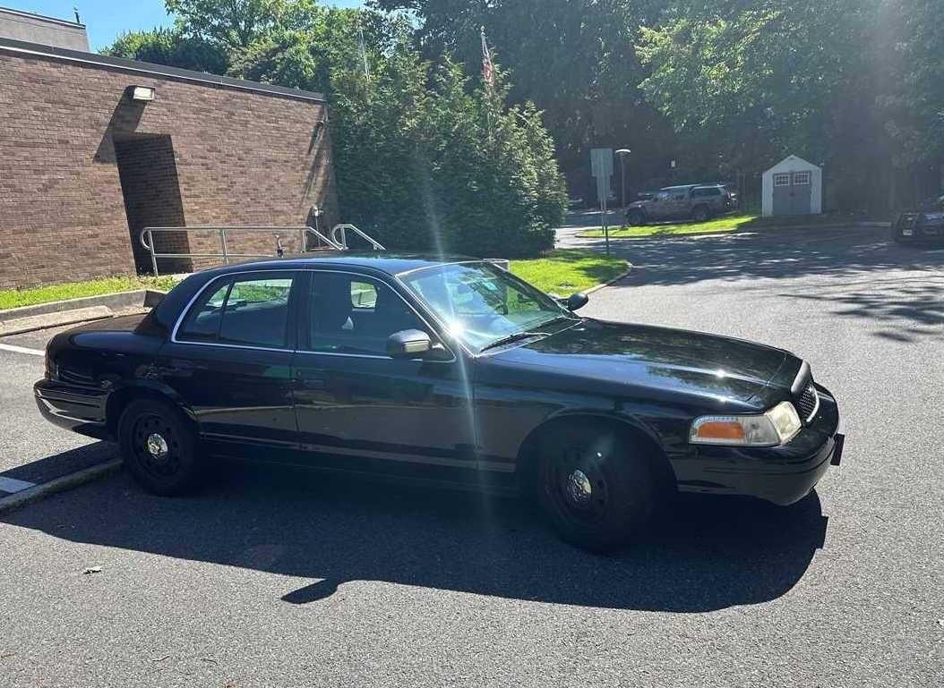 2011 black car parked in a parking lot.
