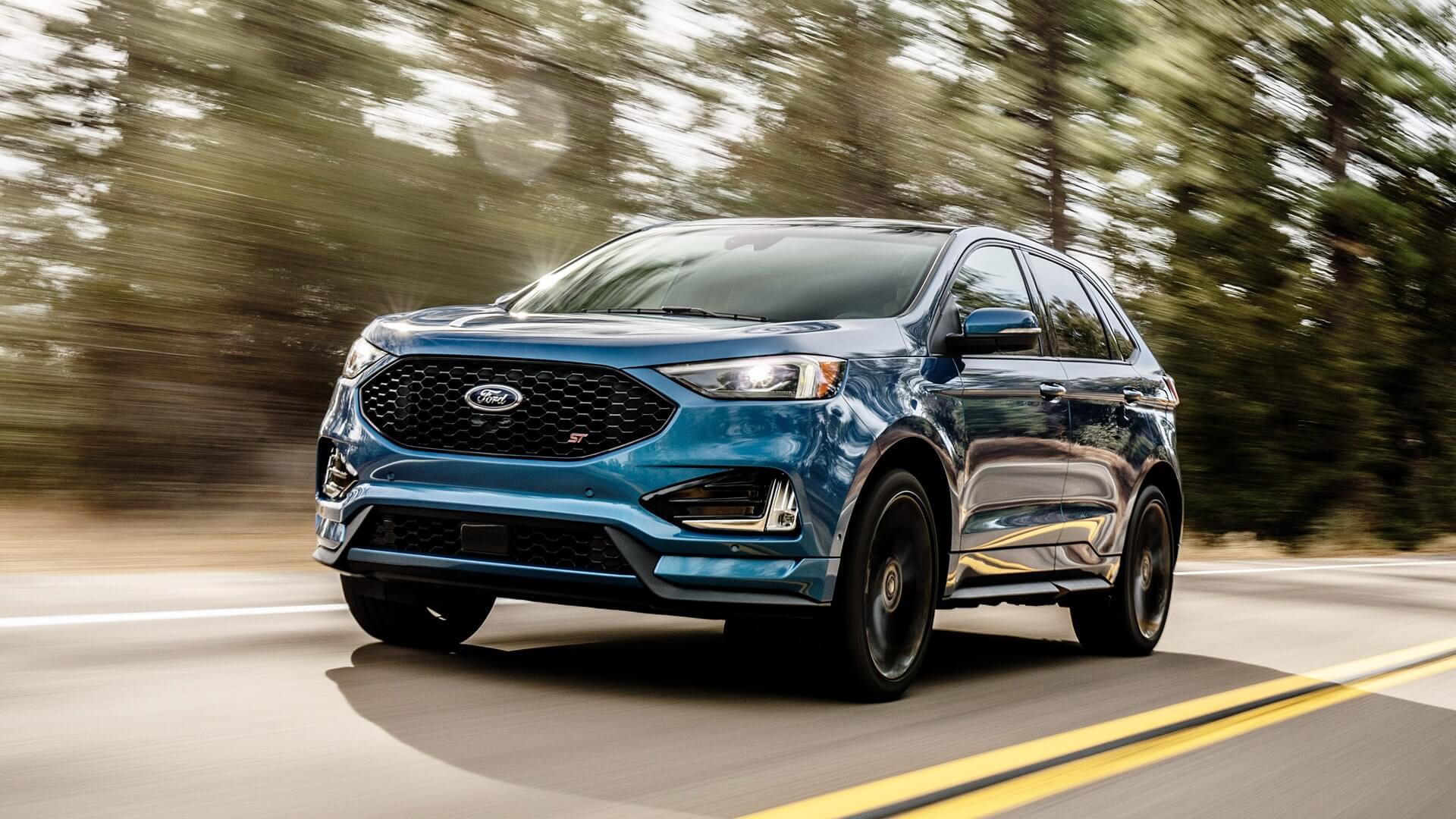 Blue Ford Edge with selectable drive modes and max towing capacity (tow rating) of 3500 pounds.