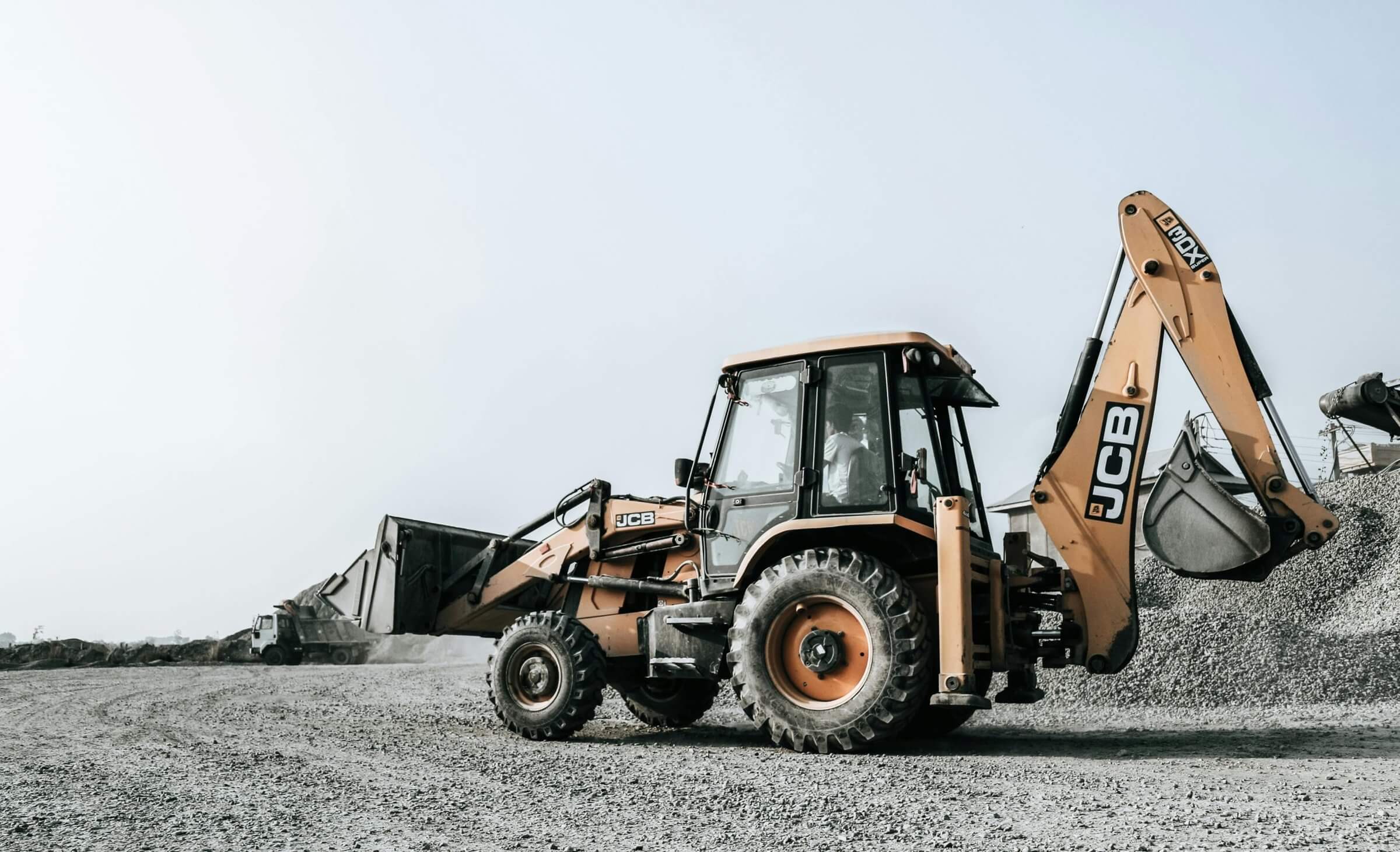 Large backhoe loader (heavy duty excavation machine) used in the construction business, with broad price range (beneficial financial consideration to review).
