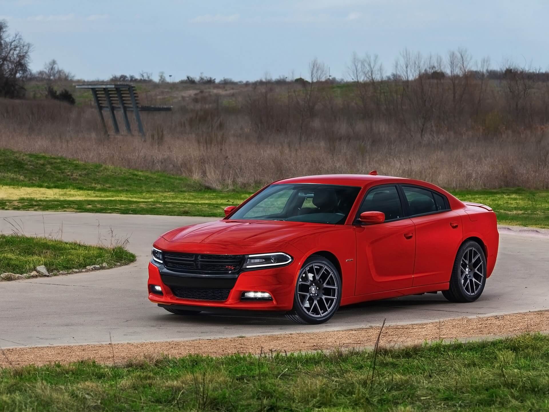 2015 Dodge Charger driving on a rural road, amongst the Dodge Charger years to avoid.