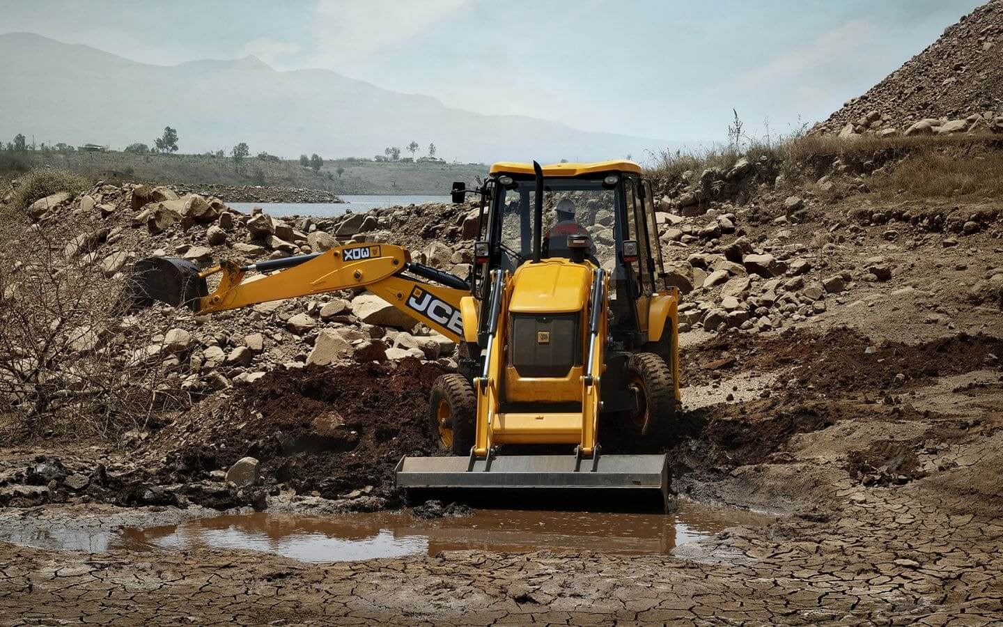 Backhoe loader with hydraulic hammers (machines and crucial equipment in construction) that have varying unit availability, brand types available.