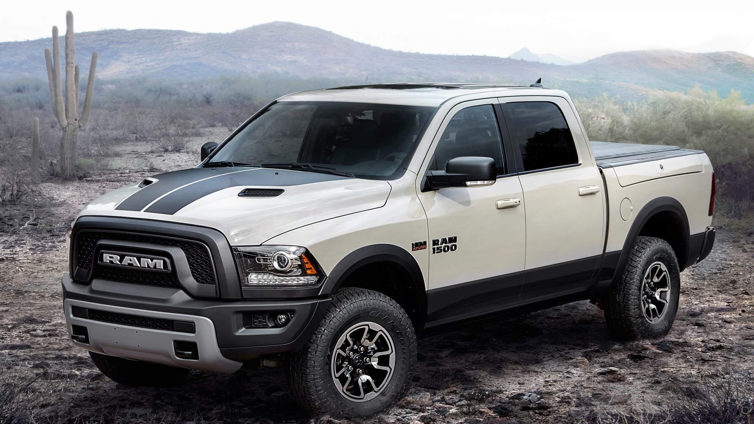 White Ram 1500, with diesel engine option, crew cab, and infotainment system, parked in the desert.