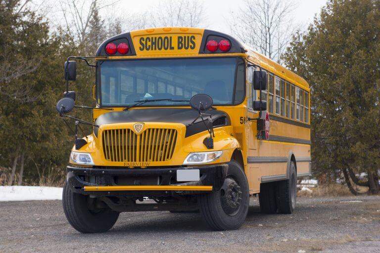 This bus has a front engine and a rear access door.