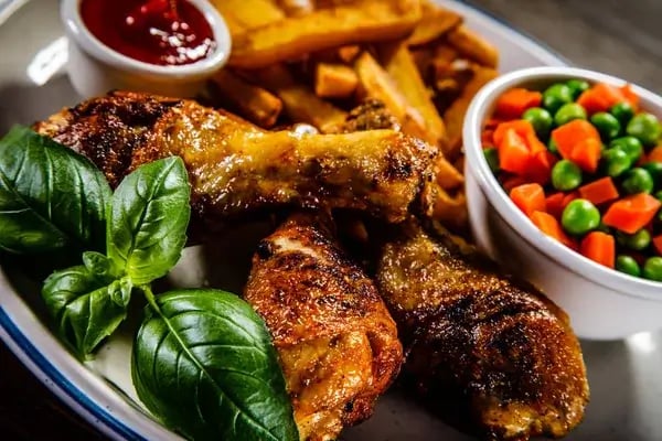 Baked chicken with spicy honey barbecue sauce served in a baking dish