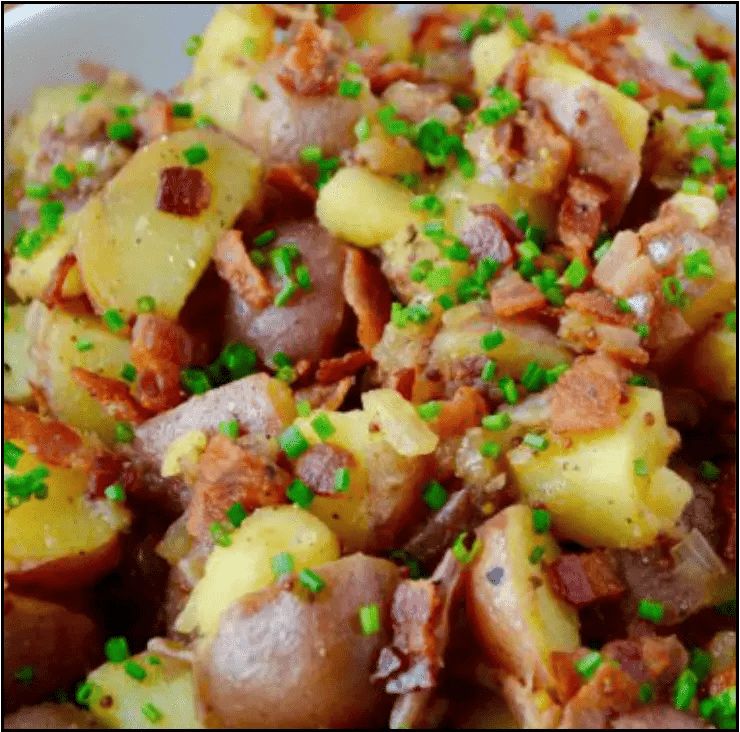 Warm potato salad with honey-Dijon dressing, bacon, and fresh herbs