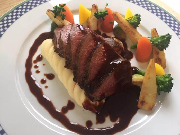 Pan seared venison loin with a red wine and dark chocolate jus