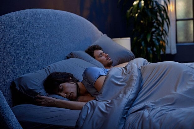 A Couple Sleeping Comfortably in SHEEX Bedding During Summertime