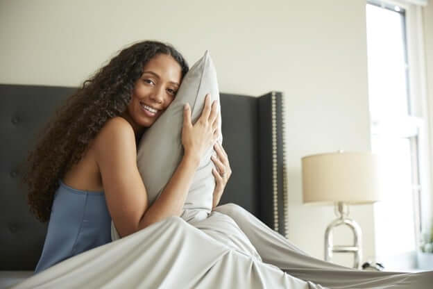 Woman Hugging Her Pillow Because of a Good Night Rest