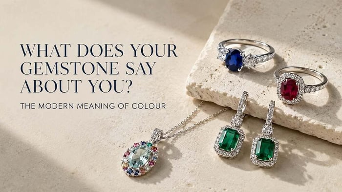 Gemstone meanings: Sapphire, ruby, emerald and aquamarine jewellery with natural diamonds arranged in a refined editorial still life.
