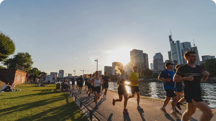 Group of runners moving outdoors at sunset, representing natural movement and proprioception