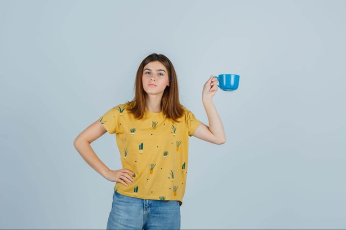 young woman posing with coffee cup