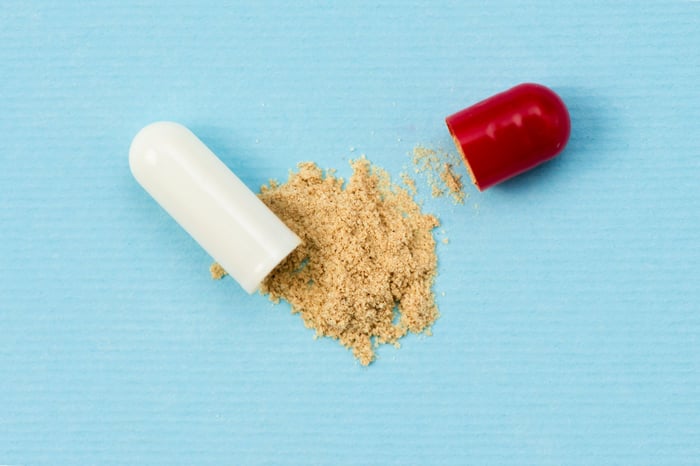 Red and white capsule leaking powder