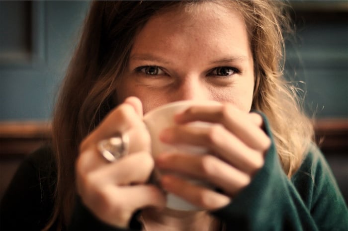 Smiling woman drinking coffee