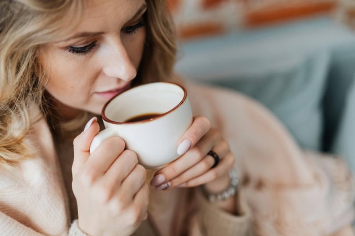 Woman savoring hot cup of coffee.