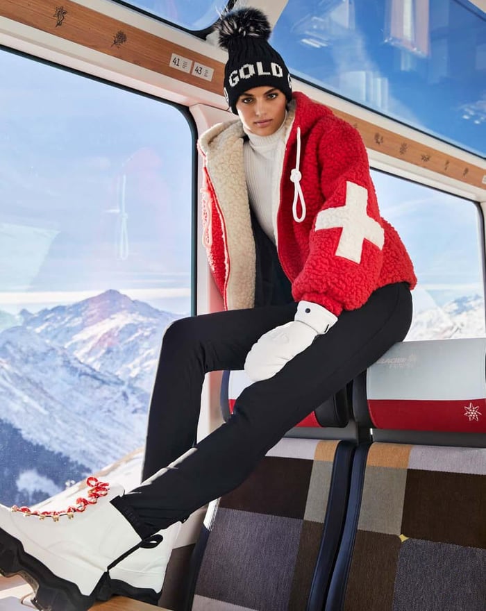 what do do on a ski holiday if yo uare not skiing? You can take a ong train ride like this lday siiting in a luxury red train carriage in the mountains