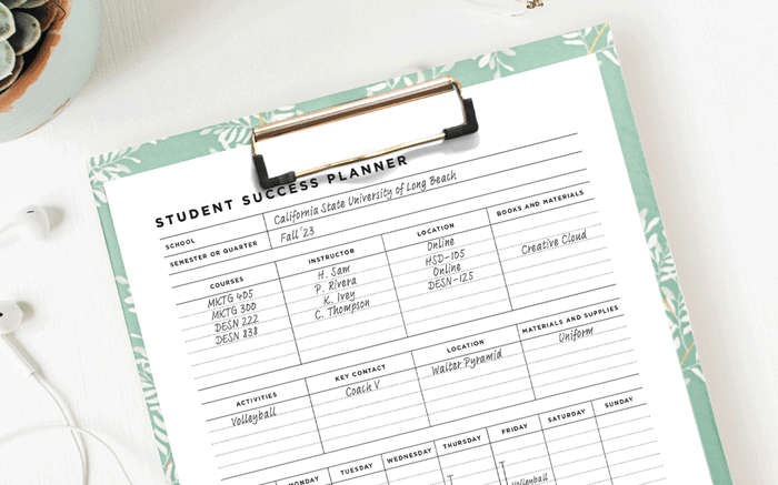 student success planner day designer printable on a green clipboard, ear buds, plant