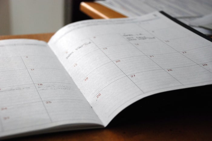Open monthly planner on a wooden desk