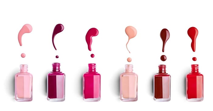 Multiple nail polish bottles of beautiful fall colors drip colorful enamel, creating a vivid beauty cosmetic scene.