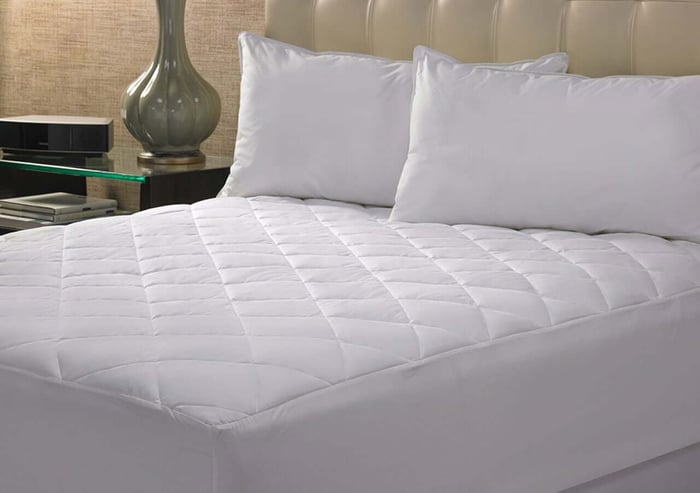 Who sells down and down-alternative comforters mattress pads in bulk for a vacation rental?