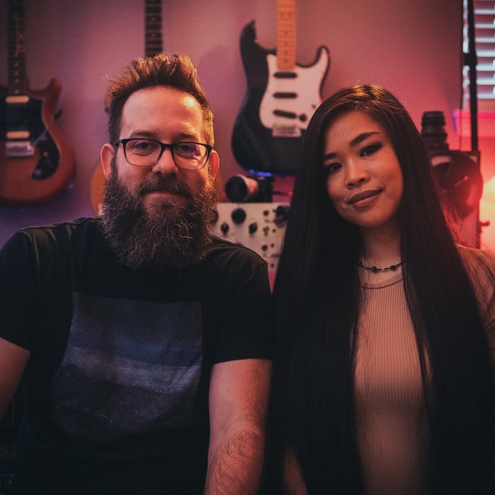 Tefty & Meems, two music creators sitting in their at studio