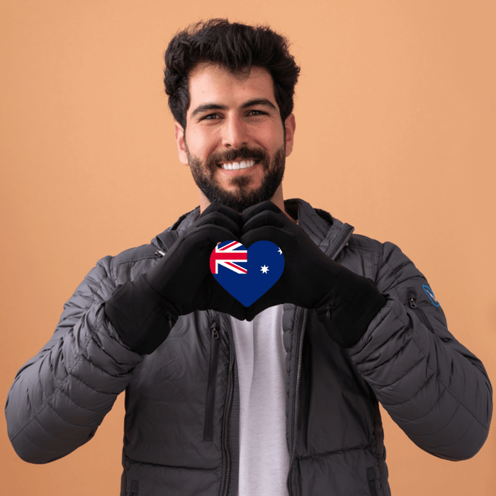 Man with an Australian flag in his hands as he makes a heart shape