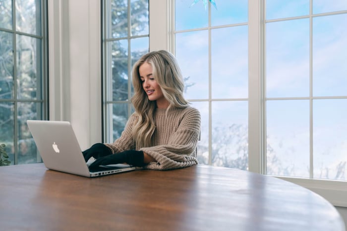 Woman typing with Toasty Touch heated gloves for Raynaud’s
