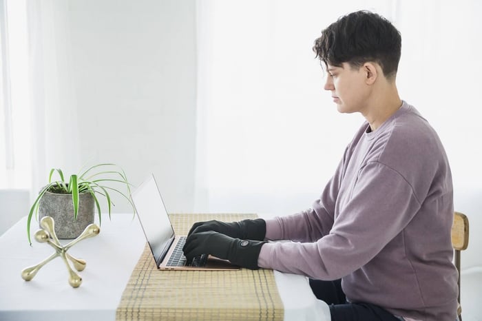 Person Typing At Computer - Raynaud’s pronunciation